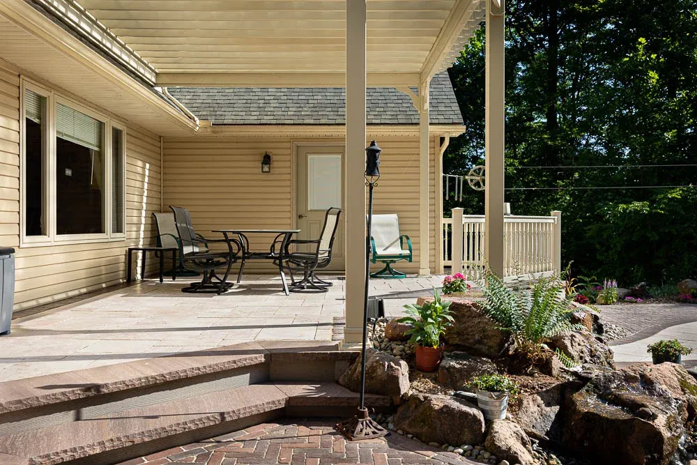Boulders and planted beds around a covered patio