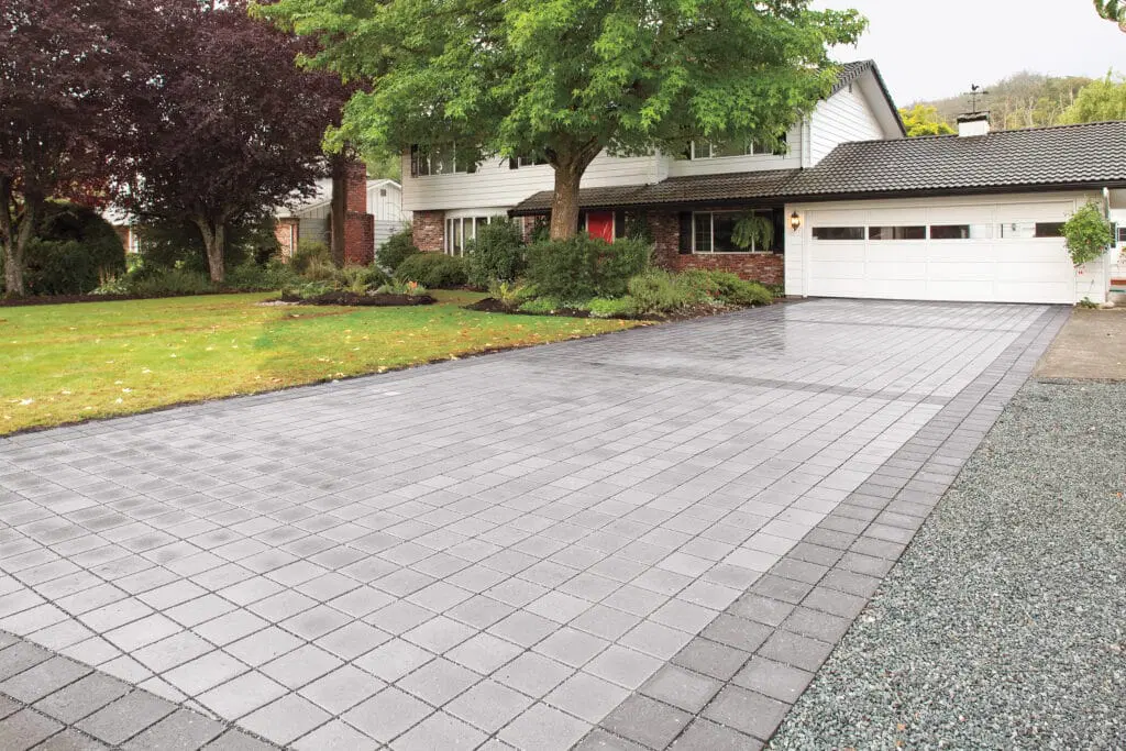 Paver driveway beside a planted edge